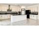 Spacious white kitchen featuring stainless steel appliances and a pantry at 9993 Birch Knoll Ave, Las Vegas, NV 89166