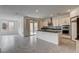 Modern open-concept kitchen features granite counters, stainless appliances, and an eat-in island at 9993 Birch Knoll Ave, Las Vegas, NV 89166