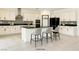 Modern kitchen features white cabinetry, a large island with seating, and stainless steel appliances at 9993 Birch Knoll Ave, Las Vegas, NV 89166