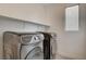 Laundry room featuring a modern Samsung front-load washer and dryer with a floating shelf at 9993 Birch Knoll Ave, Las Vegas, NV 89166