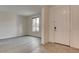 Bright, airy living room featuring wood-look floors and a large window allowing natural light at 9993 Birch Knoll Ave, Las Vegas, NV 89166