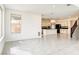 Open floor plan living room with tile floors leading to the kitchen at 9993 Birch Knoll Ave, Las Vegas, NV 89166