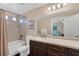 Bathroom with granite counters, dark wood cabinets, bathtub, and framed mirror at , Las Vegas, NV 89130
