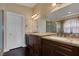 Beautiful bathroom with dark wood cabinets, granite counters, and bronze hardware at , Las Vegas, NV 89130