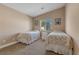 Bright bedroom with two twin beds, carpet, and a window at , Las Vegas, NV 89130