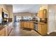 The bright kitchen features wood cabinetry, laminate flooring, and open views to the dining and living areas at , Las Vegas, NV 89130
