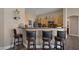 A kitchen featuring modern wood cabinets, a granite countertop island with bar stool seating at , Las Vegas, NV 89130