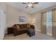 Cozy living room with comfortable sofa, ottoman, and natural light from the window at , Las Vegas, NV 89130