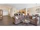 Open-concept living room featuring breakfast bar, dining area, and modern flooring at , Las Vegas, NV 89130