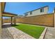Beautiful backyard featuring artificial turf, brick pavers, and low-maintenance desert landscaping at 10271 Bark Pine Ct, Las Vegas, NV 89166