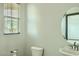 Bathroom features a modern sink, vanity, and a round mirror, lit by natural window light at 10271 Bark Pine Ct, Las Vegas, NV 89166