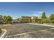 Gated community entrance offering privacy and security with well-maintained landscaping and paved road at 10271 Bark Pine Ct, Las Vegas, NV 89166
