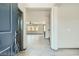 View from the foyer into the spacious, open-concept living area with tile flooring at 10271 Bark Pine Ct, Las Vegas, NV 89166