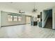 Spacious living area with tile floors, modern lighting, and seamless kitchen access at 10271 Bark Pine Ct, Las Vegas, NV 89166