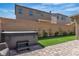 Relaxing backyard featuring artificial grass, brick pavers, privacy wall, and a hot tub, perfect for enjoying the outdoors at 10367 Andele Ave, Las Vegas, NV 89166