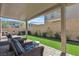 Relaxing backyard featuring a covered patio with seating, turf, privacy wall, and a hot tub at 10367 Andele Ave, Las Vegas, NV 89166