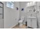 Bright bathroom featuring a modern toilet and vanity with a unique glass sink at 10367 Andele Ave, Las Vegas, NV 89166