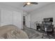Comfortable bedroom featuring a closet, a ceiling fan and a workspace with a chair at 10367 Andele Ave, Las Vegas, NV 89166