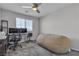 Spacious bedroom with a large beanbag, a ceiling fan and a dedicated workspace by the window at 10367 Andele Ave, Las Vegas, NV 89166