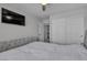Comfortable bedroom featuring a large bed, closet space and a wall-mounted TV at 10367 Andele Ave, Las Vegas, NV 89166