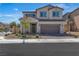 Two-story home featuring a neutral color scheme, a two-car garage, and low maintenance landscaping at 10367 Andele Ave, Las Vegas, NV 89166