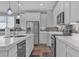 Modern kitchen with stainless steel appliances, a breakfast bar, and a light, neutral color palette at 10367 Andele Ave, Las Vegas, NV 89166