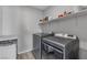 Functional laundry room equipped with modern appliances and shelving for storage solutions at 10367 Andele Ave, Las Vegas, NV 89166