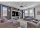 Spacious living room with a large ceiling fan, contemporary fireplace, and comfortable seating at 10367 Andele Ave, Las Vegas, NV 89166