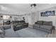 Open concept living space with a breakfast bar, modern kitchen, and comfortable seating at 10367 Andele Ave, Las Vegas, NV 89166