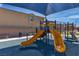 Shaded community playground featuring slides, climbing area, and soft play surface, creating a safe play environment at 10367 Andele Ave, Las Vegas, NV 89166