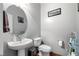 Well-lit bathroom featuring a modern sink, toilet, and 'Live Well' decor at 10766 La Florentina Ave, Las Vegas, NV 89166
