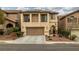 Inviting two-story home featuring a two-car garage and a charming front yard with landscaped details at 10766 La Florentina Ave, Las Vegas, NV 89166