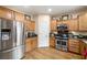 Modern kitchen with stainless steel refrigerator and oven, plus granite countertops at 10766 La Florentina Ave, Las Vegas, NV 89166