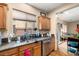 Well-lit kitchen featuring granite countertops, stainless steel appliances, and wood cabinets at 10766 La Florentina Ave, Las Vegas, NV 89166