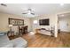 Comfortable living area with a wall-mounted TV and modern ceiling fan at 10766 La Florentina Ave, Las Vegas, NV 89166