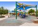 Community playground featuring colorful equipment, covered seating, and trees at 10766 La Florentina Ave, Las Vegas, NV 89166