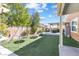 Beautiful backyard featuring artificial turf, a fire pit, and covered seating areas perfect for relaxing at 1112 Adobe Creek Ct, North Las Vegas, NV 89084