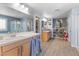 A spacious bathroom with double sinks, a shower, and storage shelves at 1112 Adobe Creek Ct, North Las Vegas, NV 89084