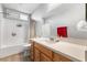Bright bathroom featuring a wood vanity, large mirror, and shower with a curtain at 1112 Adobe Creek Ct, North Las Vegas, NV 89084