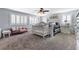 A spacious bedroom with a ceiling fan, shutters, and neutral carpeting at 1112 Adobe Creek Ct, North Las Vegas, NV 89084