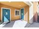 Charming home entryway showcasing a blue front door with tasteful decor, an extra closet door, and a welcoming covered porch at 1112 Adobe Creek Ct, North Las Vegas, NV 89084