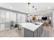 Bright kitchen features white countertops, gray cabinets, pendant lights, and an island with bar seating at 1112 Adobe Creek Ct, North Las Vegas, NV 89084