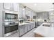 Modern kitchen with gray cabinetry, stainless steel appliances and white counters at 1112 Adobe Creek Ct, North Las Vegas, NV 89084