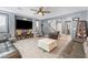 Spacious living room with hardwood floors, a large entertainment center, comfortable seating, and a ceiling fan at 1112 Adobe Creek Ct, North Las Vegas, NV 89084