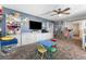 Bright playroom with shelves, cabinets, a TV, and a small table with chairs at 1112 Adobe Creek Ct, North Las Vegas, NV 89084