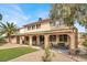 Spacious backyard featuring a covered patio, manicured turf, and lush landscaping for outdoor enjoyment at 1307 Summer Dawn Ave, Henderson, NV 89014