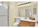 Functional bathroom with a walk-in shower, single sink vanity, and a large mirror above the toilet at 1307 Summer Dawn Ave, Henderson, NV 89014