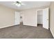 A spacious bedroom features neutral walls, plush carpeting, and access to another room at 1307 Summer Dawn Ave, Henderson, NV 89014