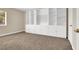 A spacious bedroom features neutral walls, plush carpeting, and built-in shelving with lots of room for storage at 1307 Summer Dawn Ave, Henderson, NV 89014