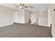 Spacious bonus room with neutral carpeting, ceiling fan and view to the hallway at 1307 Summer Dawn Ave, Henderson, NV 89014